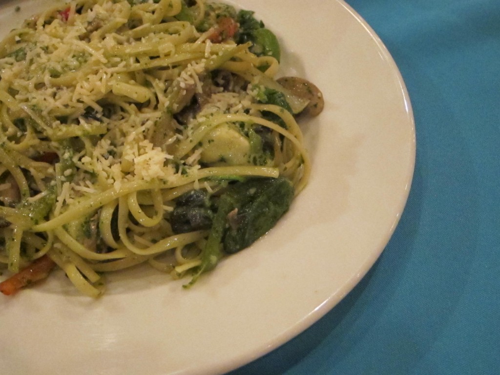 Spaghetti with pesto, artichokes, olives, spinach, mushrooms, and onions